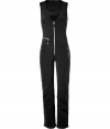 Make a chic statement on the slopes in Jet Sets ultra modern stretch ski overalls, finished with a flattering cut guaranteed to show off your sporty side in style - Snapped scooped neckline, sleeveless, exposed front zip, zippered pockets, seamed knees, zippered ankles, inside elasticized cuff lining with silicon band for hold - Form fitting through the thigh, straight leg, slightly flared ankle - Wear with form-fitting turtlenecks and glamorous oversized sunglasses